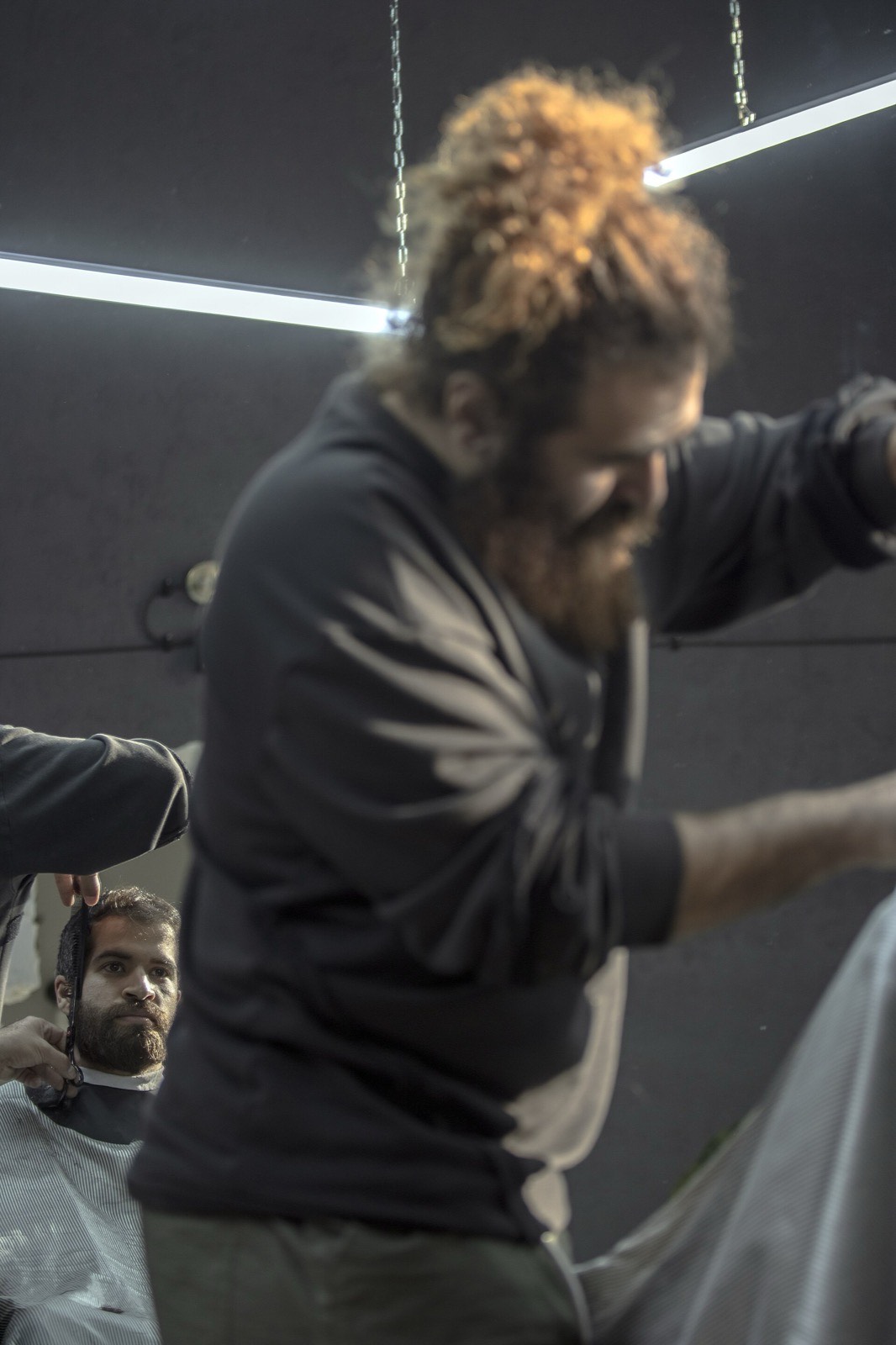 Salon scene: a stylist mid-cut.
