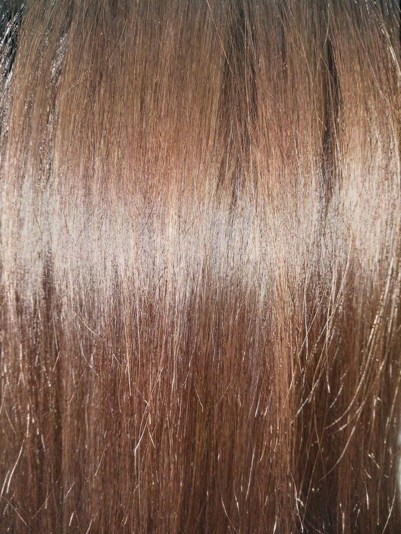 Detail of brunette hair showing depth and shine.