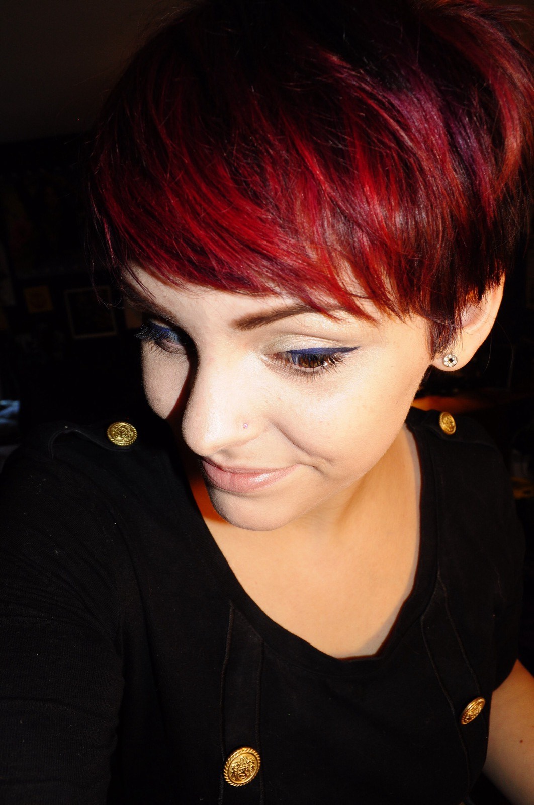 A red pixie haircut, vivid colour.